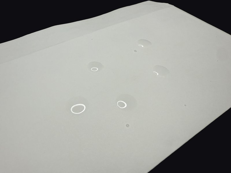 Water still beading on the card shipping envelope after five minutes
