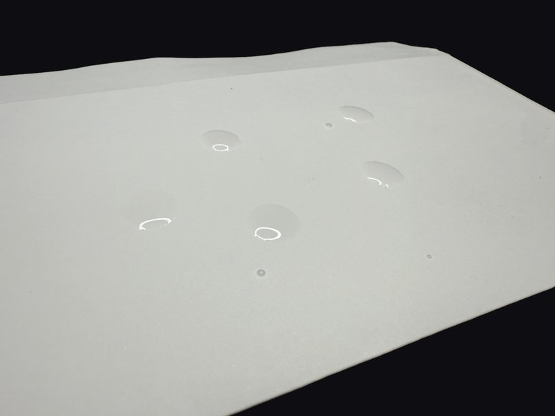 Water drops applied to the water-resistant trading card envelope